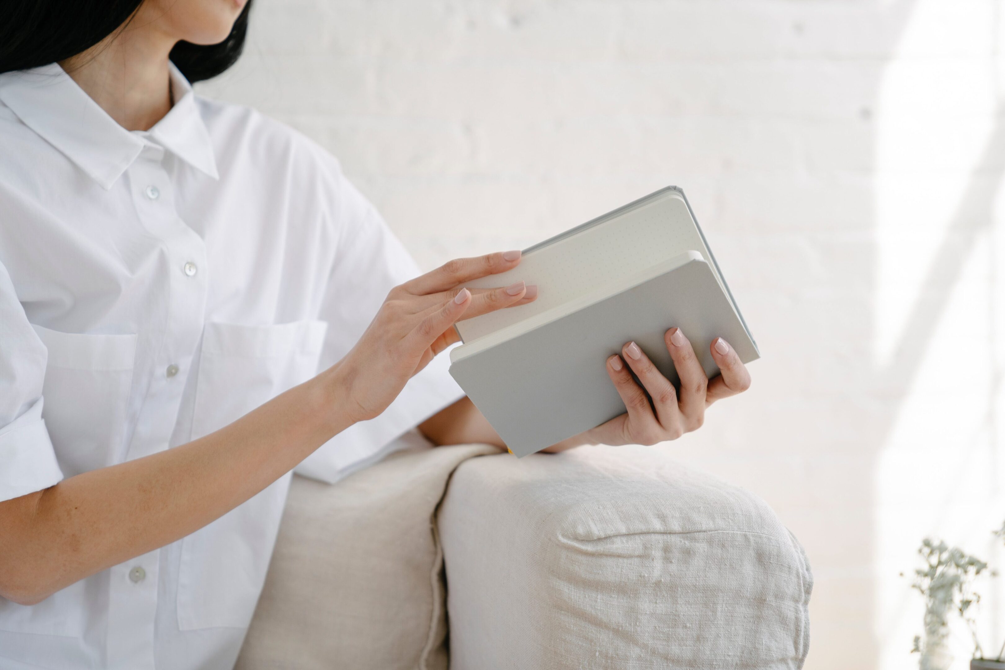 A person sitting on a couch holding an ipad
